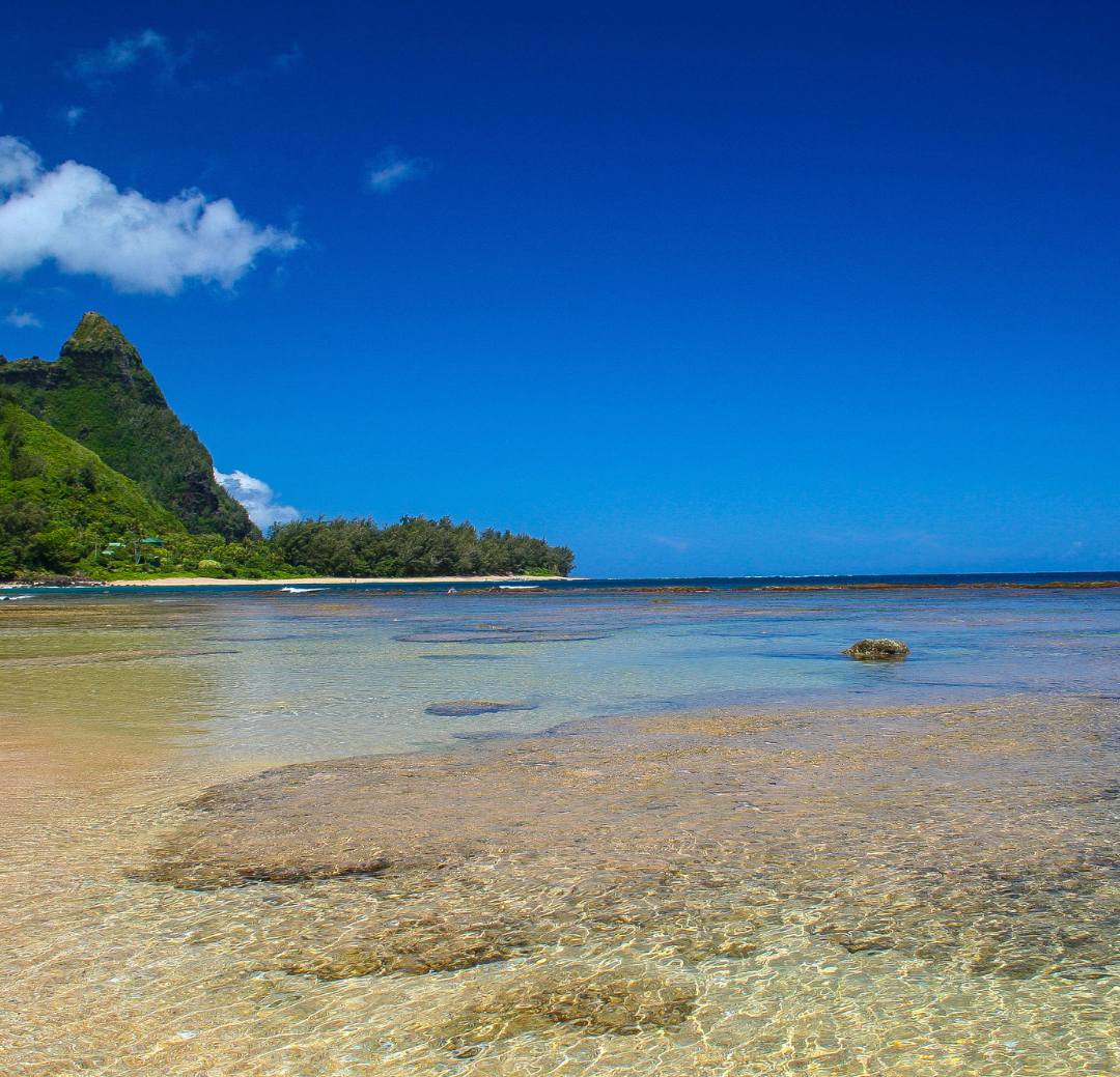 Tunnels Beach on Kauai's north shore featuring turquoise lagoon waters, coral reef formations, and the iconic Bali Hai mountain backdrop